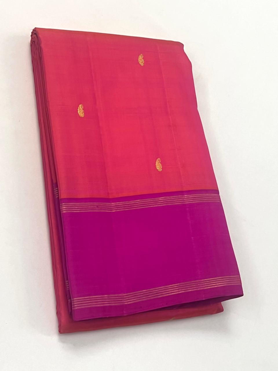Orange Kanchipuram Silk Saree with a Contrast Pink Zari Border